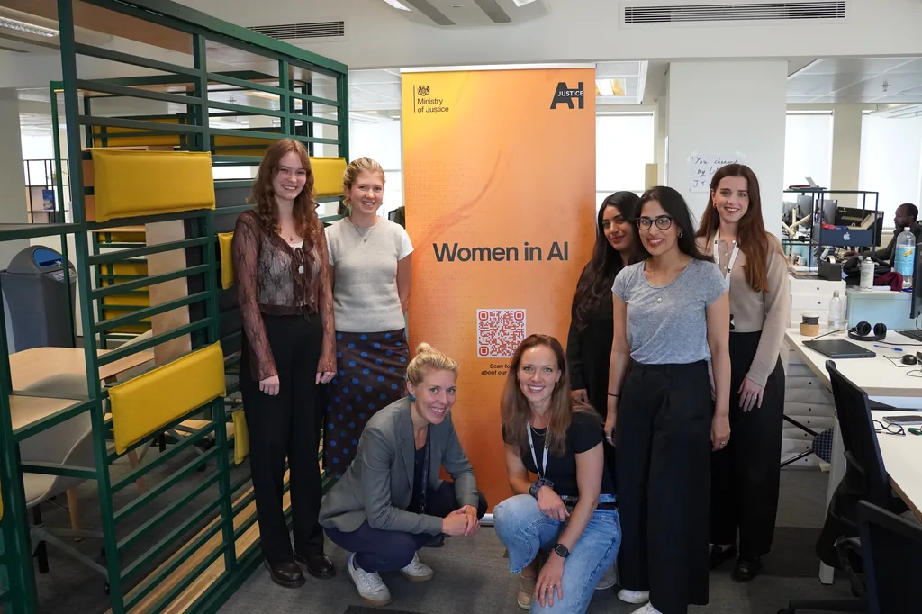 Members of the Women in AI network gathered around the network's banner